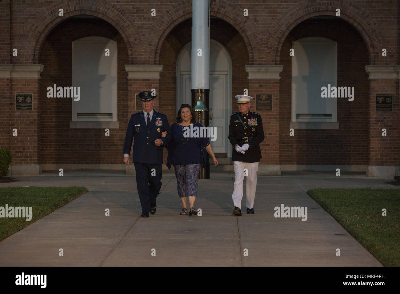 U.S. Air Force Lt. Gen. Thomas J. Trask, vice commander of Headquarters U.S. Special Operations Command (SOCOM), left, Barbara Trask, center, and Director Marine Corps Staff Lt. Gen. James B. Laster, right, walk down centerwalk prior to an evening parade at Marine Barracks Washington, Washington, D.C., June 23, 2017. Evening parades are held as a means of honoring senior officials, distinguished citizens and supporters of the Marine Corps. (U.S. Marine Corps photo by Lance Cpl. Stephon L. McRae) Stock Photo
