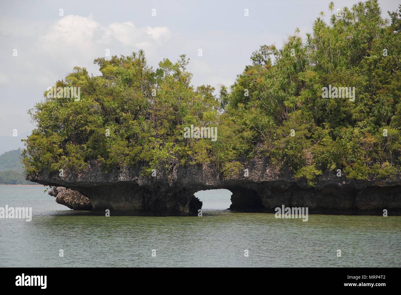 An artistic cut underneath two rocky islands in Cantilan, Surigao del Sur, Philippines Stock Photo