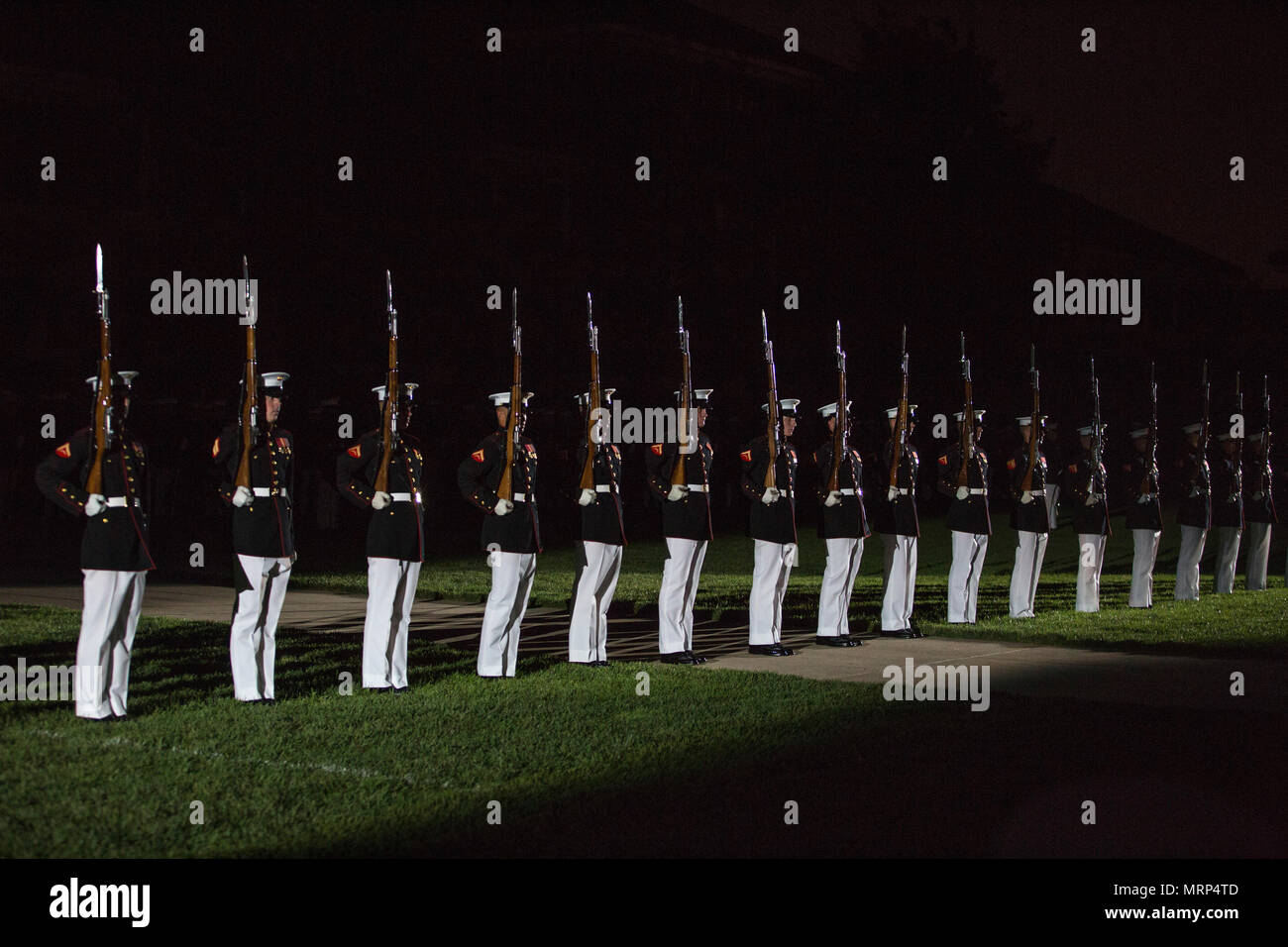 The Marine Corps Silent Drill Platoon performs during an evening parade at Marine Barracks Washington, Washington, D.C., June 23, 2017. Evening parades are held as a means of honoring senior officials, distinguished citizens and supporters of the Marine Corps. (U.S. Marine Corps photo by Stephon L. McRae) Stock Photo