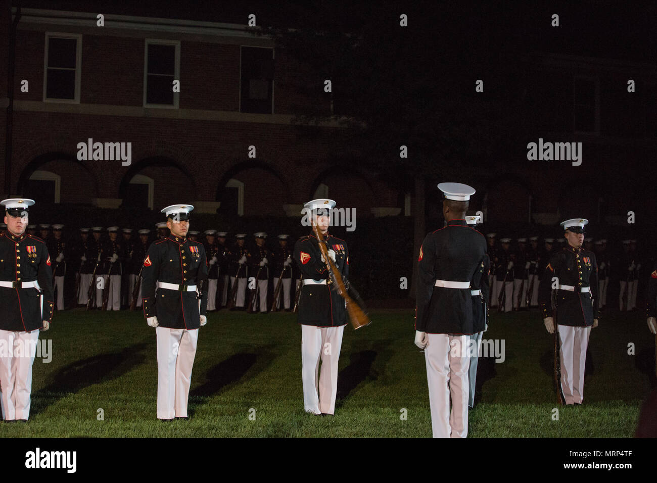 The Marine Corps Silent Drill Platoon performs during an evening parade at Marine Barracks Washington, Washington, D.C., June 23, 2017. Evening parades are held as a means of honoring senior officials, distinguished citizens and supporters of the Marine Corps. (U.S. Marine Corps photo by Stephon L. McRae) Stock Photo