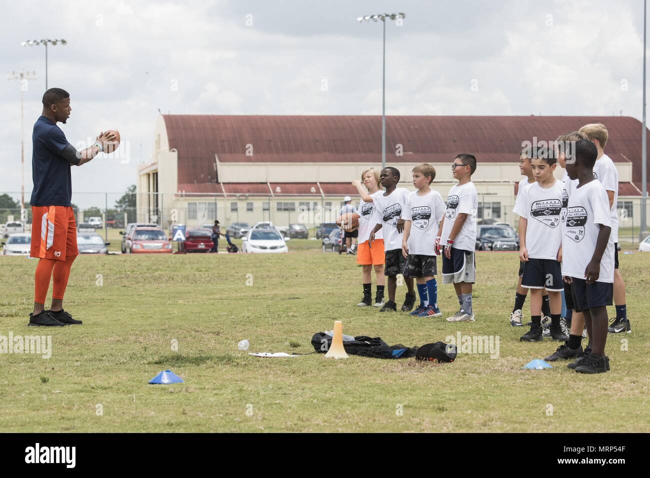 Terrance Williams, Dallas Cowboys wide receiver, coaches children during a  youth football camp June 26, 2017, at Joint Base San Antonio-Randolph.  JBSA-Randolph was one of the 11 military communities selected to host