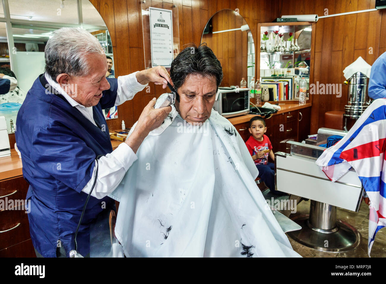 Mexico City,Hispanic,Mexican,Alvaro Obregon San Angel,barbershop,haircut,cutting hair,trimming sideburns,man men male,boy boys,ki Stock Photo