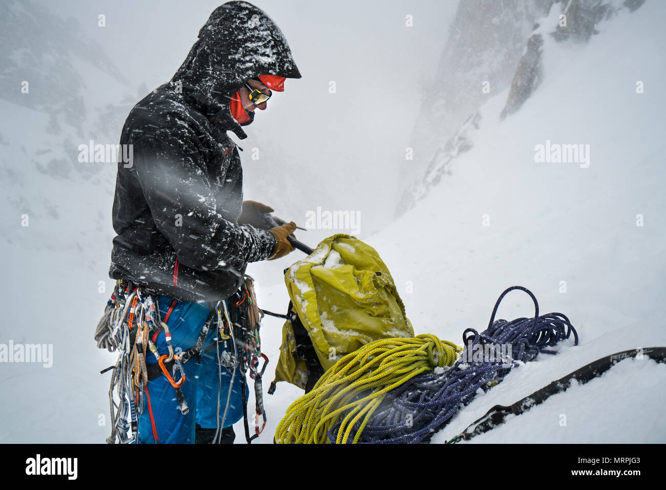 one man packs his gear away at the end of the day Ice Climbing Stock Photo