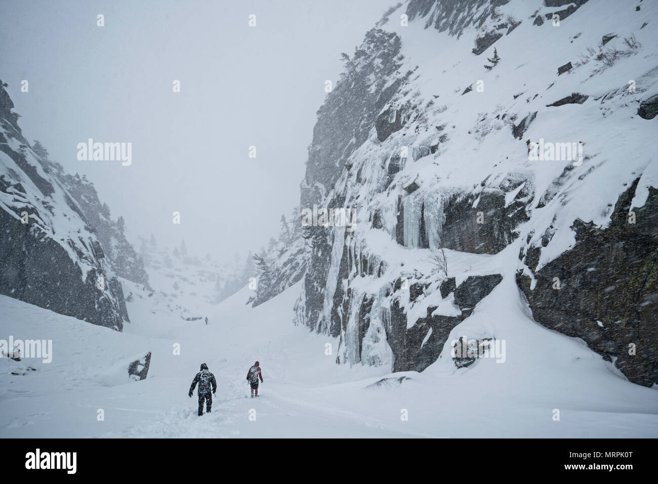 climbers make they're way down canyon after a day of ice climbing Stock Photo