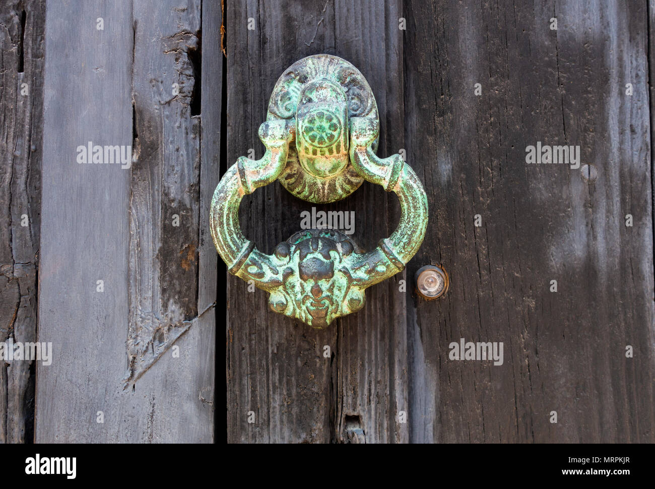A bronze door handle turned green with age, from copper carbonate Stock