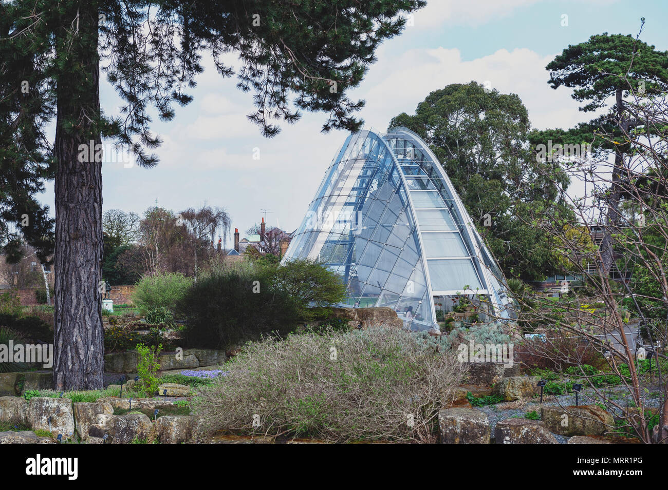 London, UK - April 2018: Davies Alpine House, modern building designed to provide perfect condition for alpine plants, located in Kew Gardens Stock Photo
