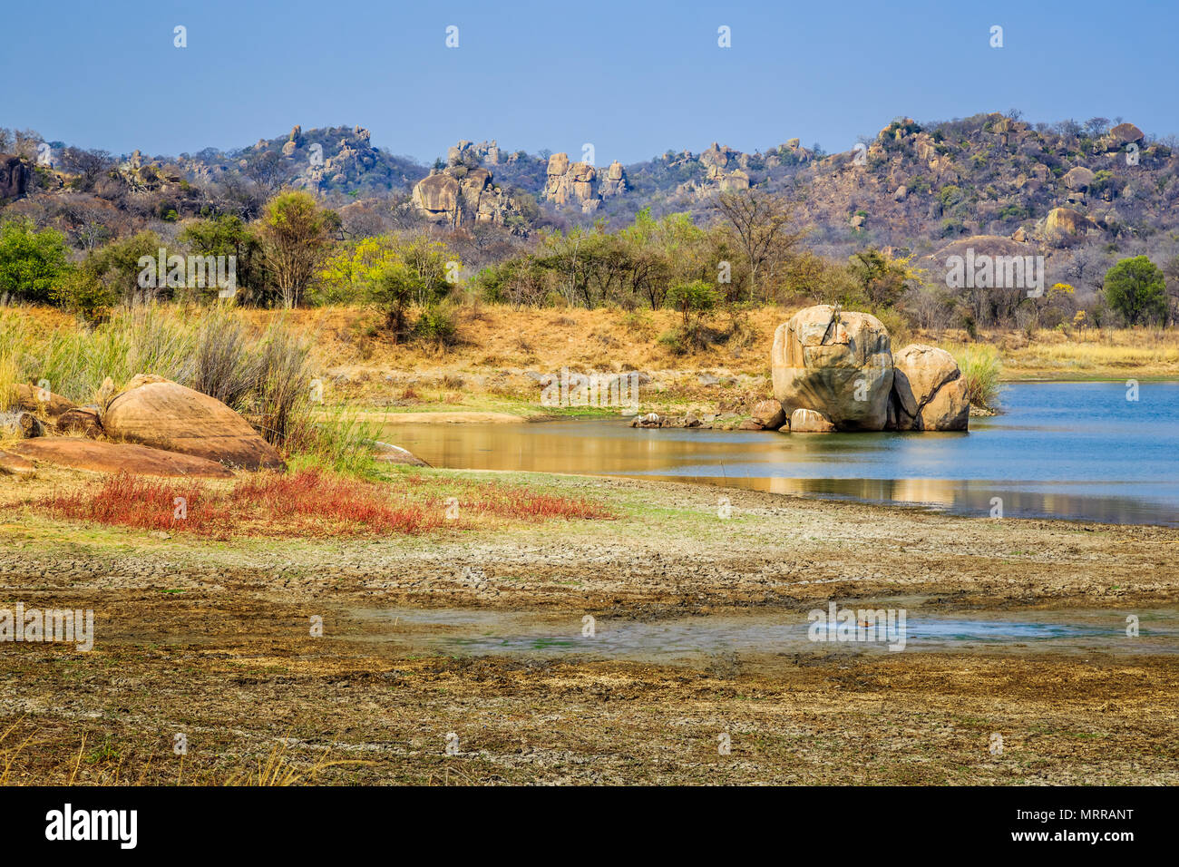 View of a lake surrounded by rocks, in Matobo National Park, Zimbabwe. September 26, 2016. Stock Photo