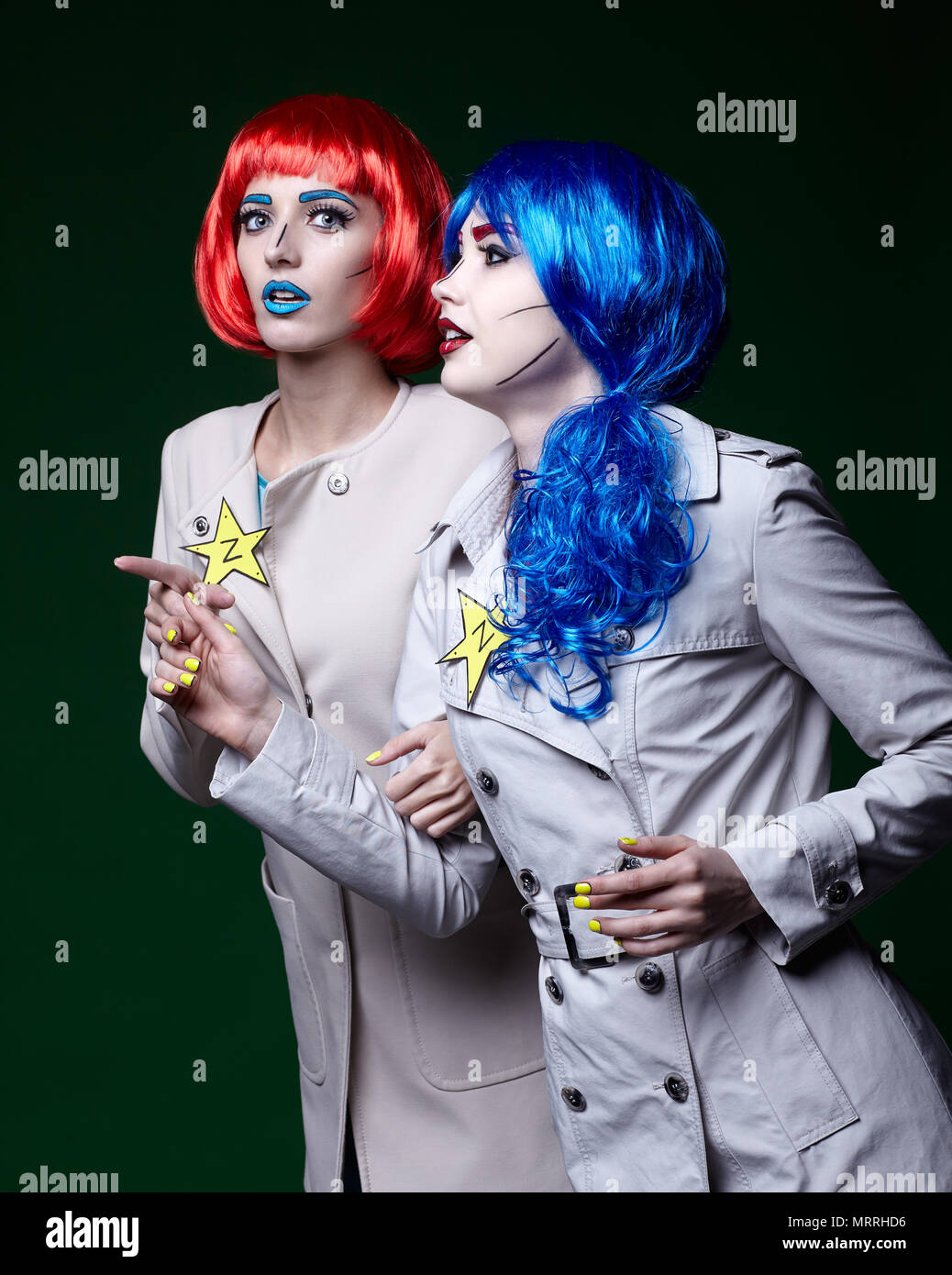 Portrait of young women in comic pop art make-up style on dark background.  Female detectives investigate a crime Stock Photo - Alamy