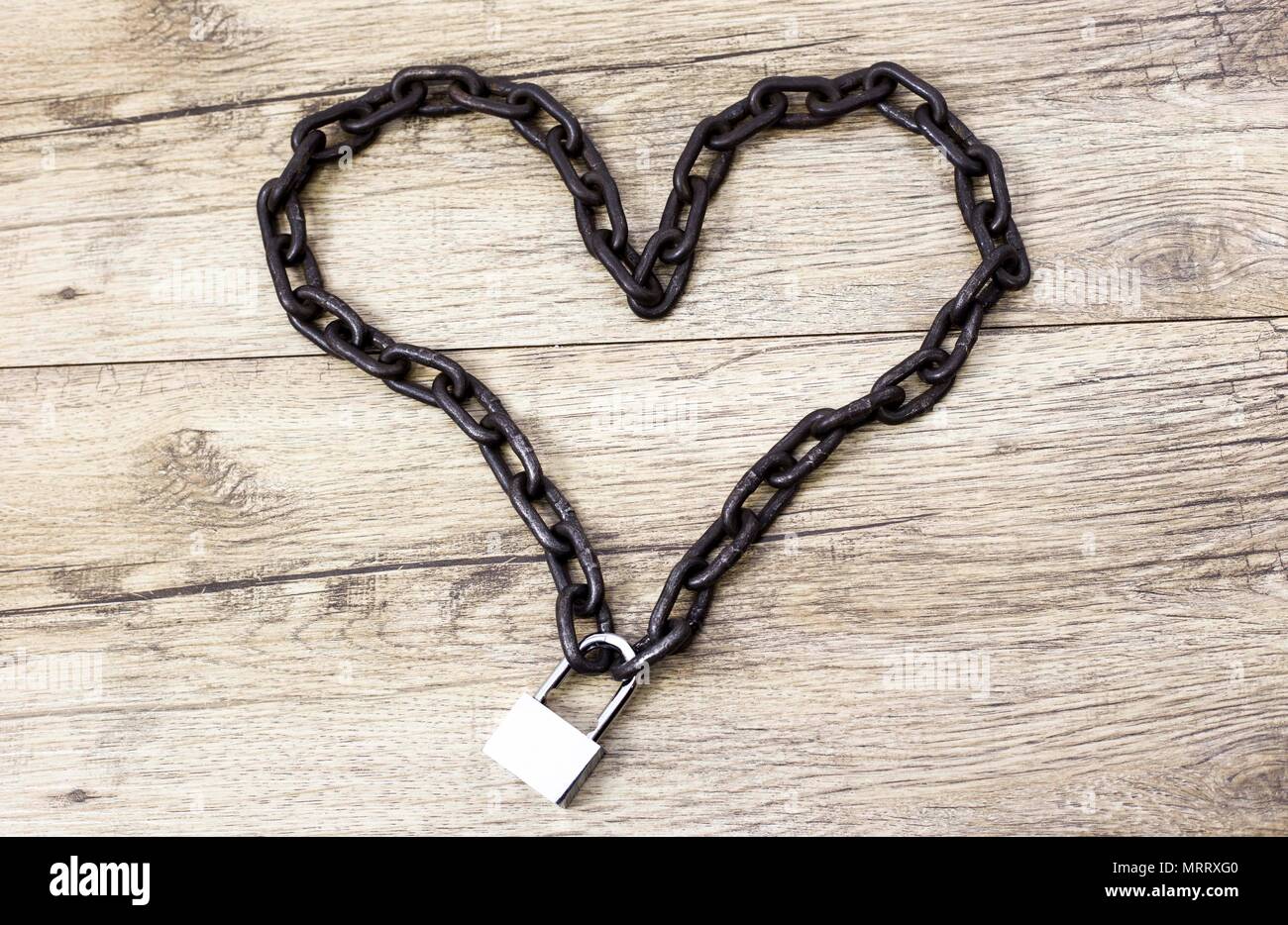 Rusty chain heart shape on the lock Stock Photo