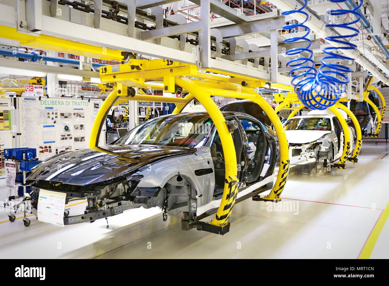 Car production line with unfinished cars in a row at Maserati factory. Stock Photo