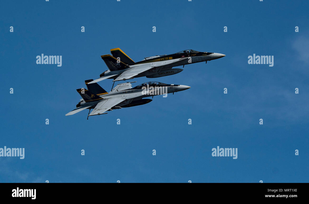 170626-N-QI061-376  ATLANTIC OCEAN (June 26, 2017) An F/A-18E Super Hornet assigned to the Gunslingers of Strike Fighter Squadron (VFA) 105, top, and an F/A-18F Super Hornet assigned to the Fighting Swordsmen of Strike Fighter Squadron (VFA) 32 fly over the flight deck of the aircraft carrier USS Dwight D. Eisenhower (CVN 69)(Ike). Ike is underway during the sustainment phase of the Optimized Fleet Response Plan (OFRP). (U.S. Navy photo by Mass Communication Specialist 3rd Class Nathan T. Beard) Stock Photo