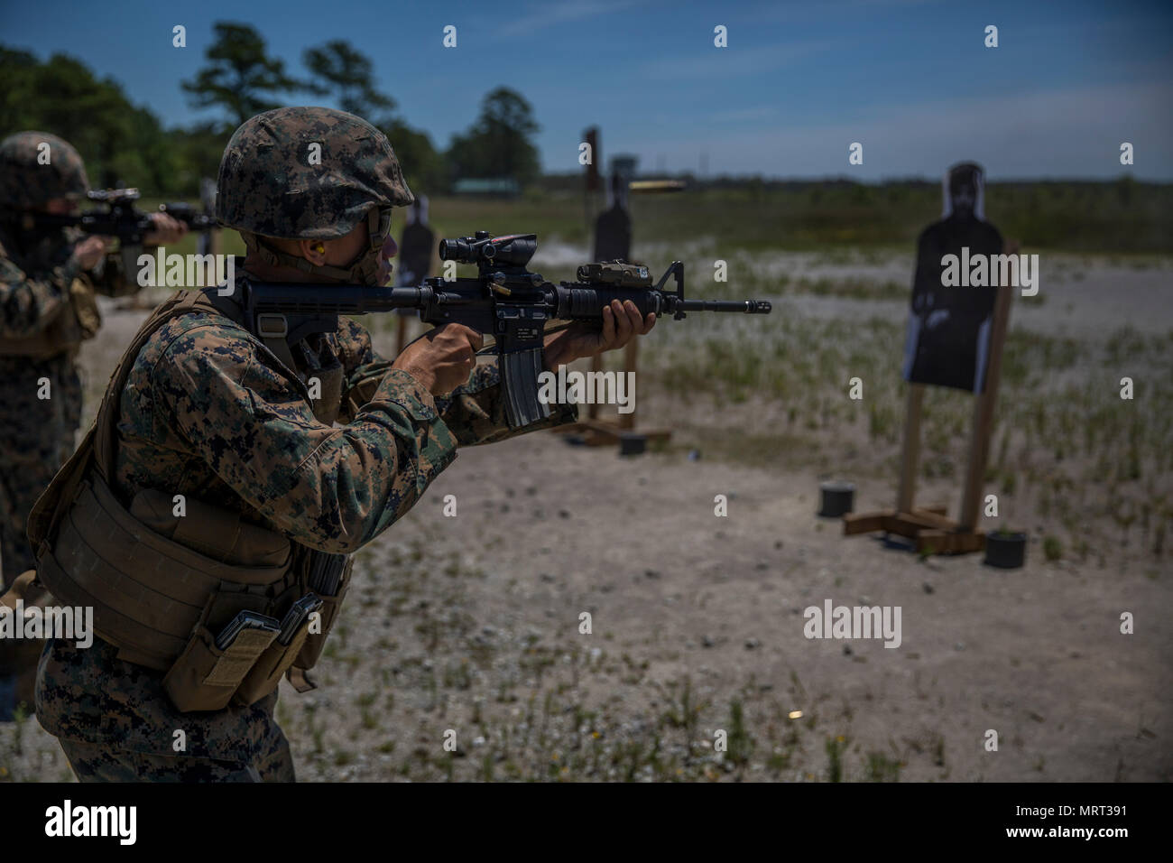 A Marine performs a hammer pair drill, rapidly shooting the target twice at  Camp Lejeune, N.C., June 28, 2017. The Marines conducted a combat  marksmanship program to enhance their capabilities as riflemen.