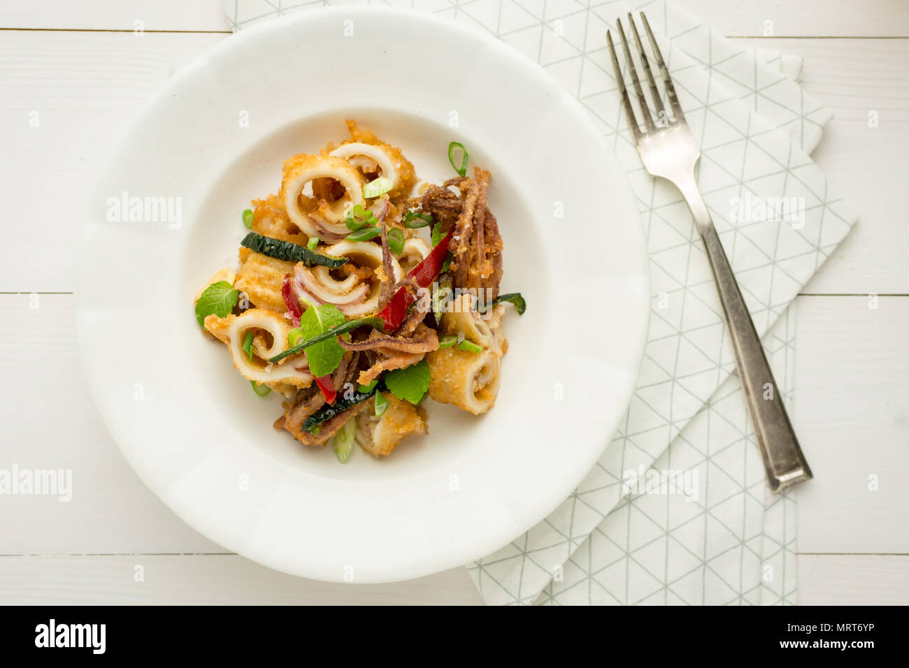 Fried Squids Tentacle Calamari with Chili Pepper and Mint Leaves Stock Photo