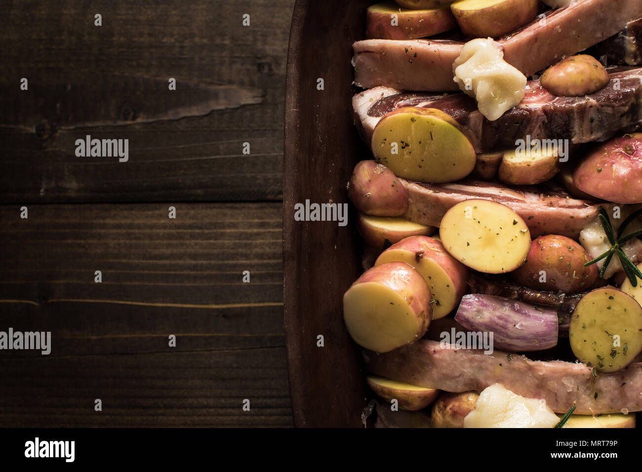 Lamb Loin Chops and Vegetables Prepared for Roasting. Copy Space Stock