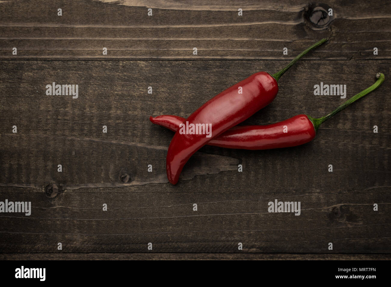 Red Hot Chili Peppers on Rustic Wooden Background Stock Photo