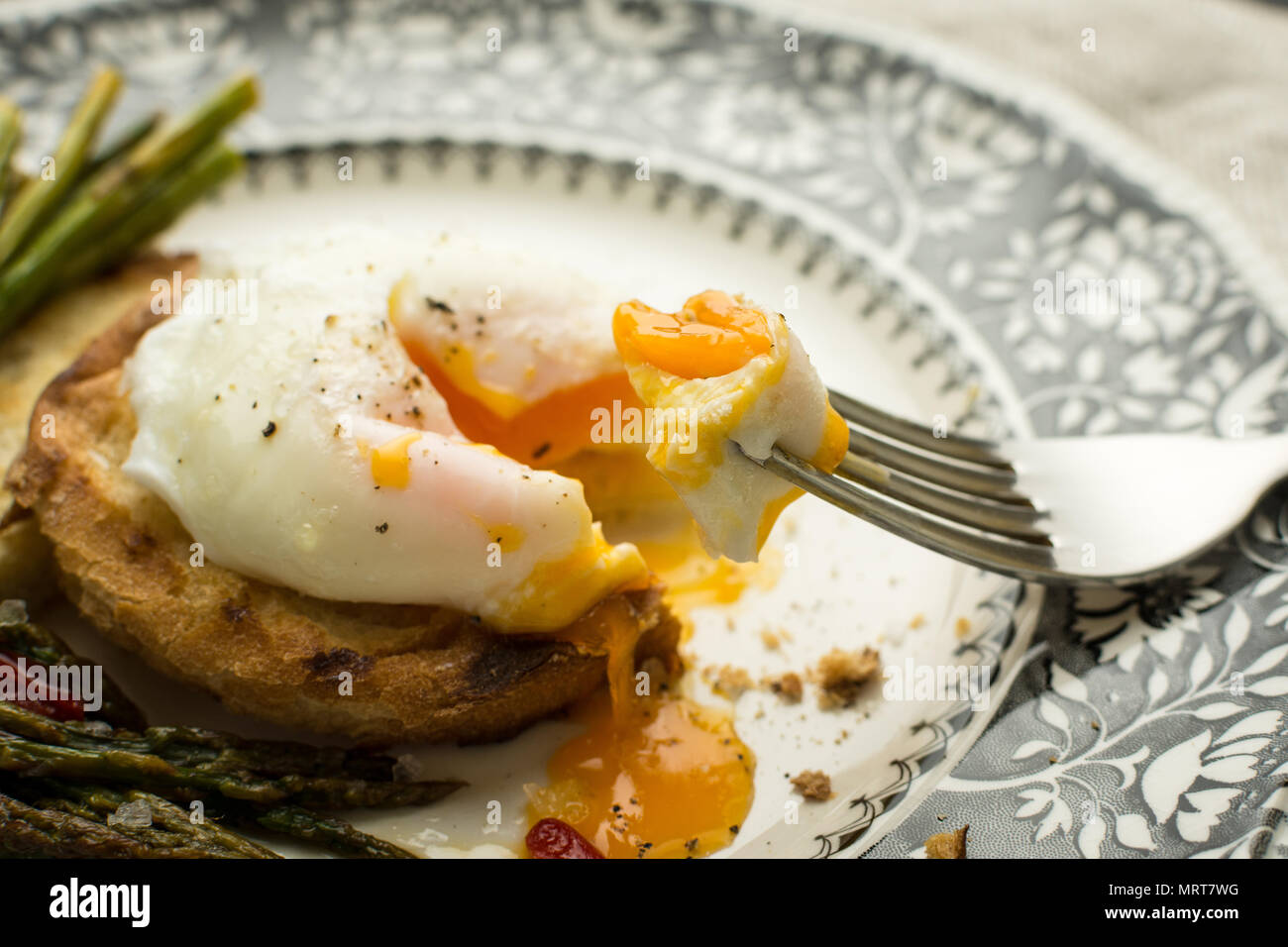 Poached Egg on Toasted Bread With Green Asparagus and Chili Peppers Stock Photo
