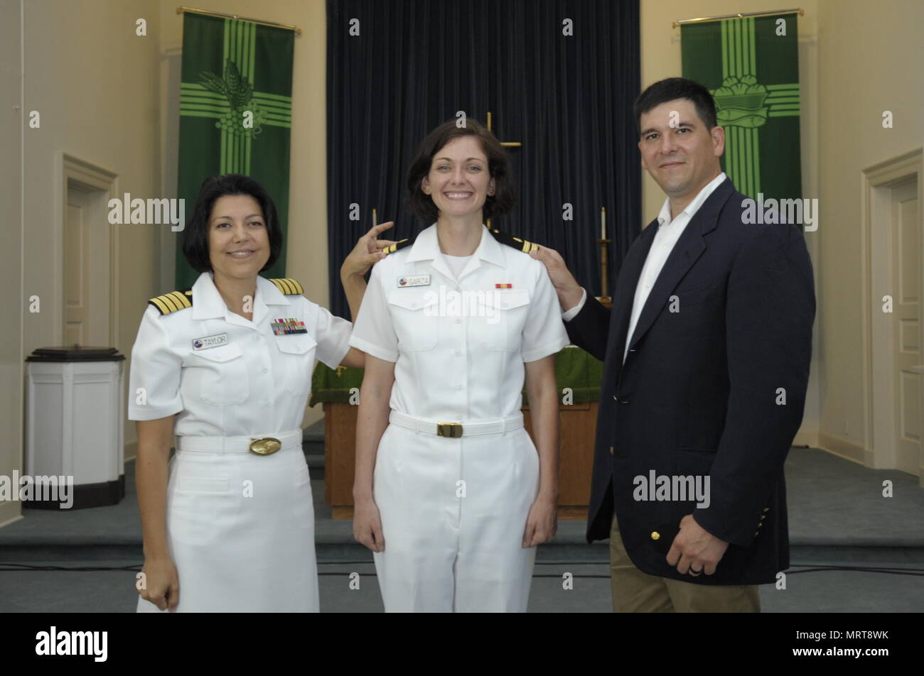 CORPUS CHRISTI, Texas (June 30, 2017) Naval Health Clinic (NHC) Corpus Christi Senior Nurse Executive (SNE), Capt. Kimberly Taylor, and Family Nurse Practitioner (FNP) Lt. Brittany Garza with her husband, Jose Garza, during her promotion ceremony at the Naval Air Station Corpus Christi Protestant Chapel June 30. (U.S. Navy photo by Bill W. Love/RELEASED) 170630-N-KF478-012 Stock Photo