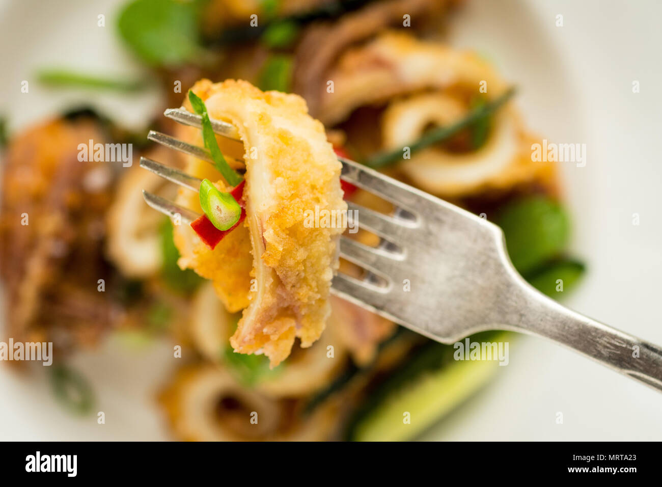 Fresh Fried Squids, Chili Pepper and Mint Leaves on White Plate Stock Photo