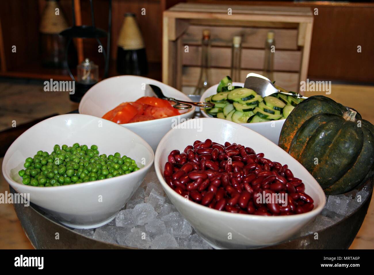 Red Beans Peas Tomatoes And Sliced Cucumber On Top Of Ice Cubes
