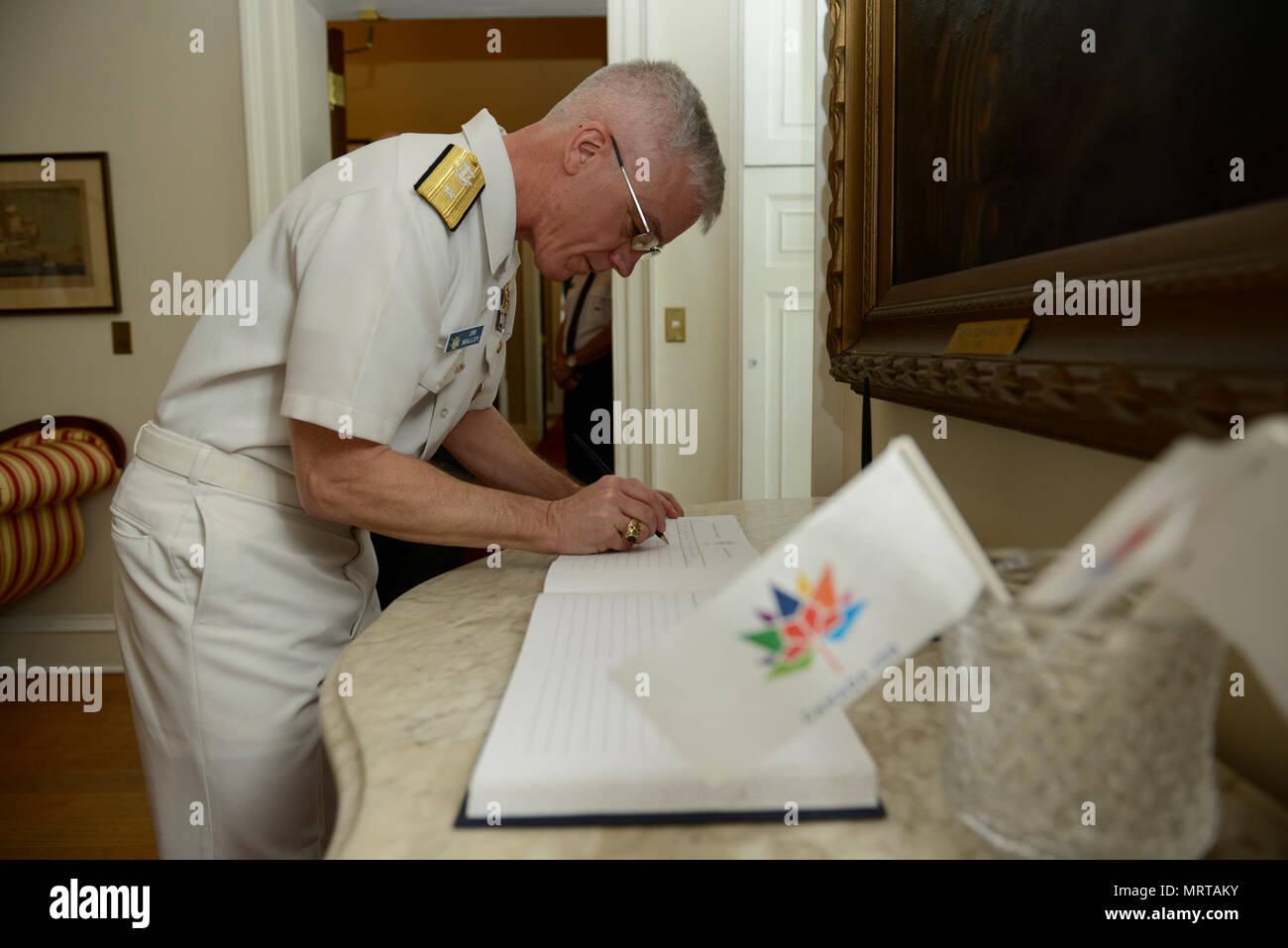 170629-N-YZ751-070   HALIFAX, Nova Scotia (June 29, 2017) Rear Adm. Jim Malloy, commander of Carrier Strike Group (CSG) 10, signs a guest book before meeting with Nova Scotia Lieutenant-Governor Arthur LeBlanc. Malloy is meeting senior leadership in Halifax, Nova Scotia, as part of the Canada 150 anniversary celebration with the aircraft carrier USS Dwight D. Eisenhower (CVN 69)(Ike) port visit. (U.S. Navy photo by Mass Communication Specialist 1st Class Tony D. Curtis) Stock Photo