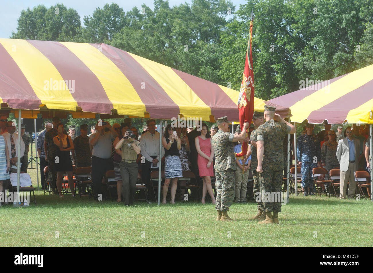 Col. Todd Oneto, H&S Bn. commander passes on the colors to Col. John Atkinson as part of change of command ceremonies held at Lejuene Hall June 23. Stock Photo