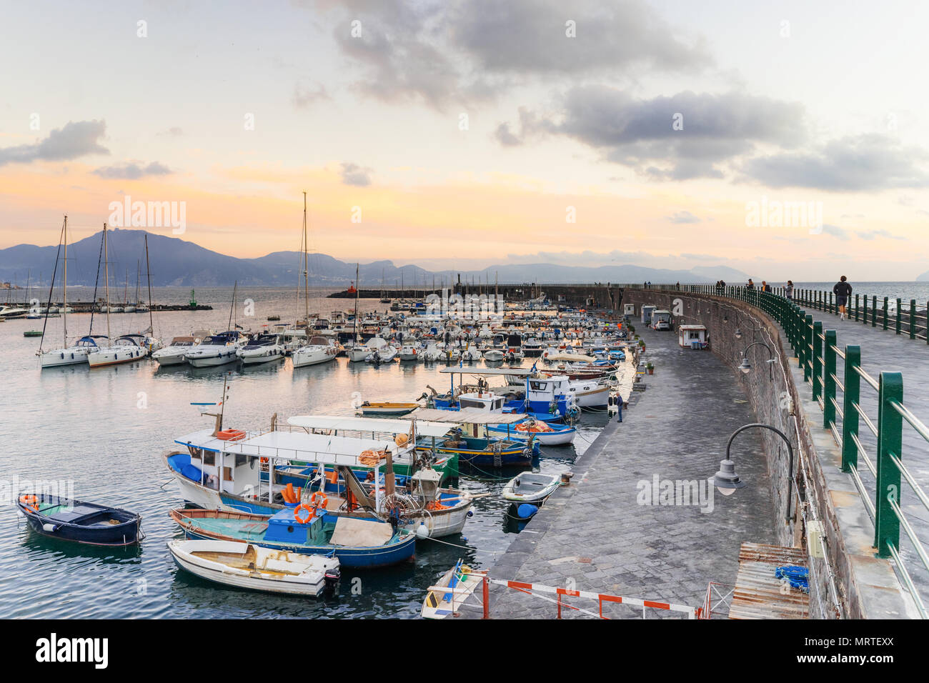 TORRE DEL GRECO, NAPLES, ITALY - NOVEMBER 12, 2017: scenic view of the sea and boats in the port at sunset, on background Sorrento peninsula Stock Photo