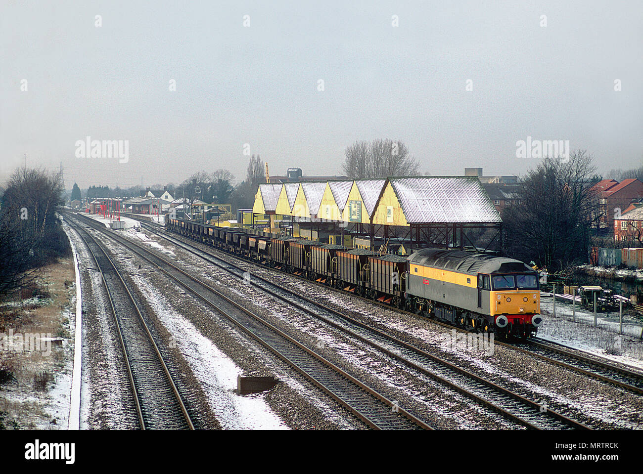 A class 47 diesel locomotive number 47315 heads east towards London with a loaded ballast working at West Drayton on the 7th January 1994. Stock Photo
