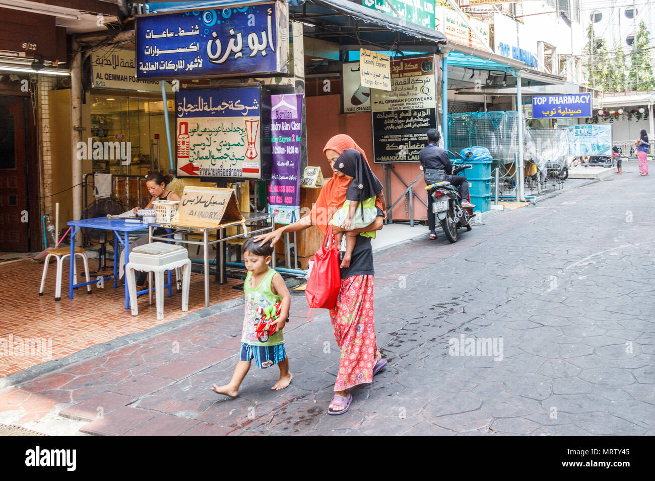 Bangkok, Thailand-25th March 2017: Middle eastern woman with children walking down Sukhumvit soi 3. The area is known as the Arab Soi. Stock Photo