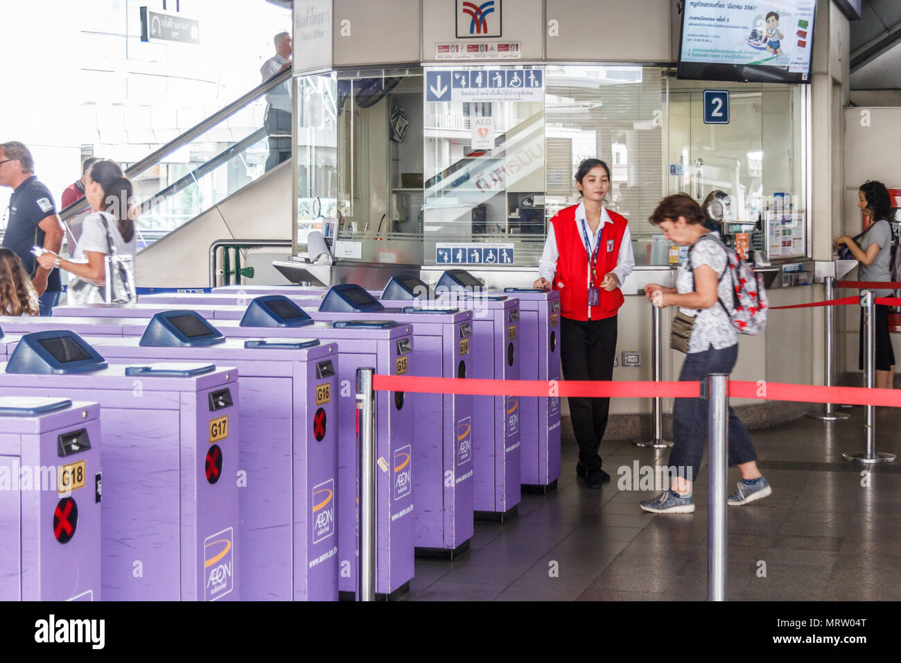 Bangkok, Thailand-28th March 2018:  Asoke BTS station. Passengers go through entry turnstiles. Stock Photo