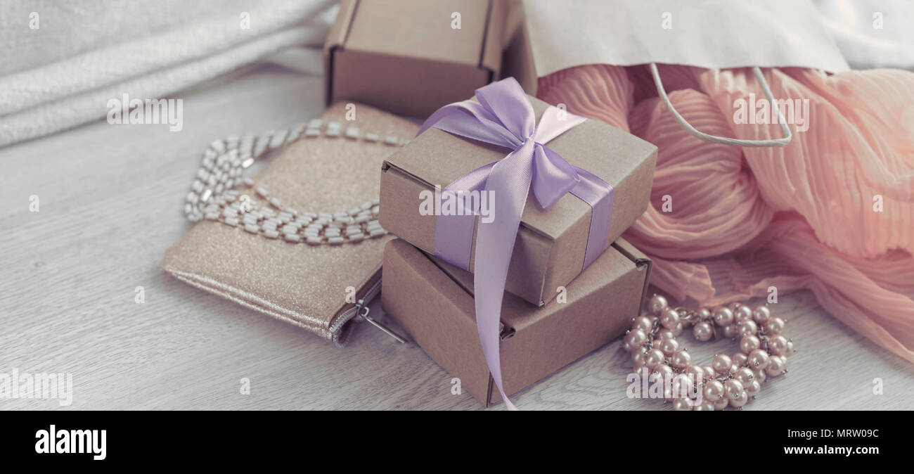 Decorative composition in retro style set of boxes with gifts. Crafting boxes on wooden background. Women's jewelry earring necklace bracelet Stock Photo