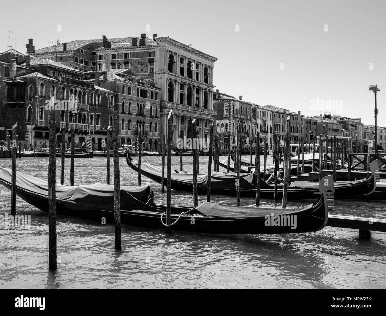 Gondola boats anchored in the ports of Grand Canal in the City of Canals - Venice, Italy Stock Photo