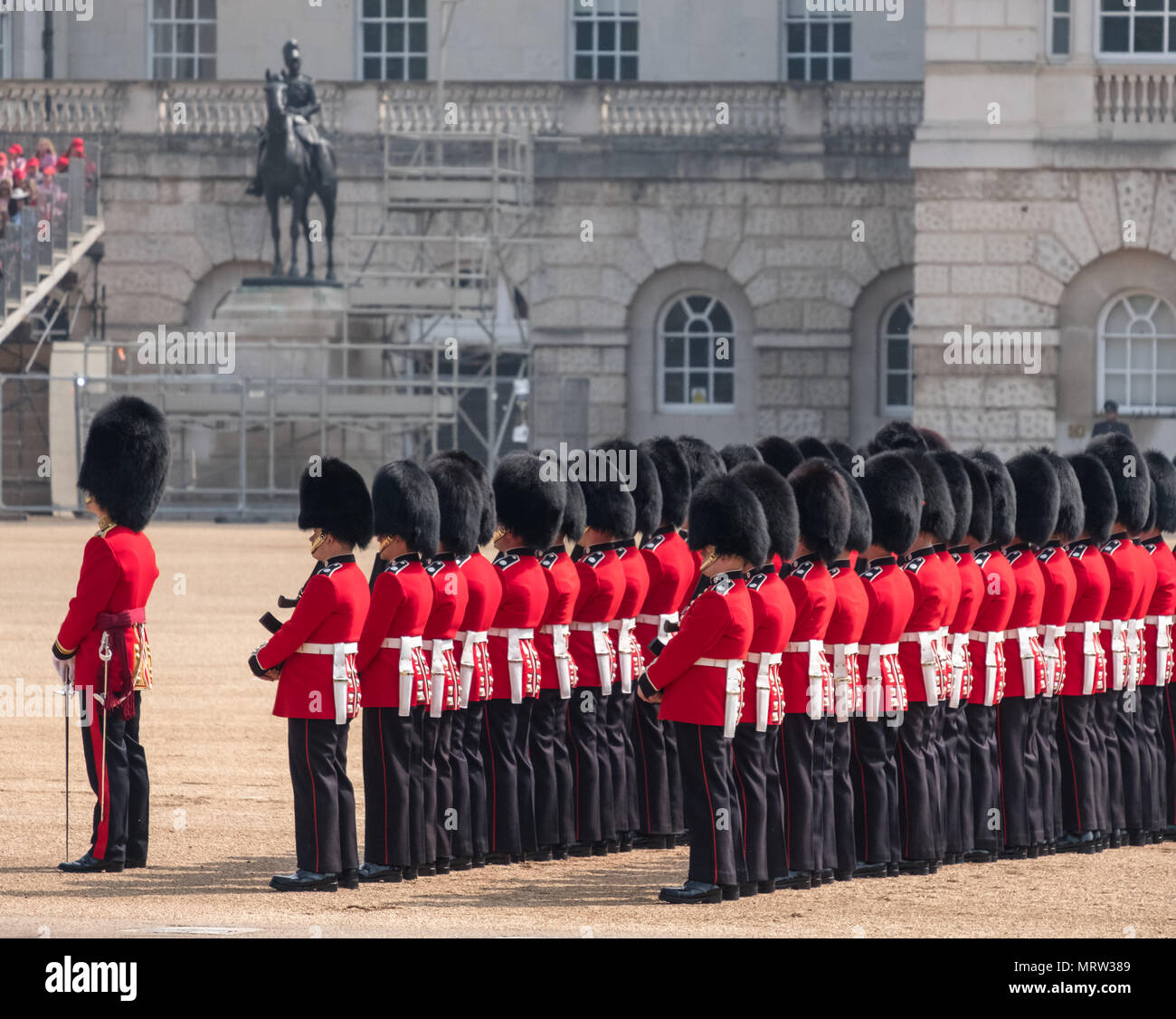 Trooping the Colour military ceremony in London UK, with Coldstream Guards lined up in their red and black traditional uniform and bearskin hats Stock Photo