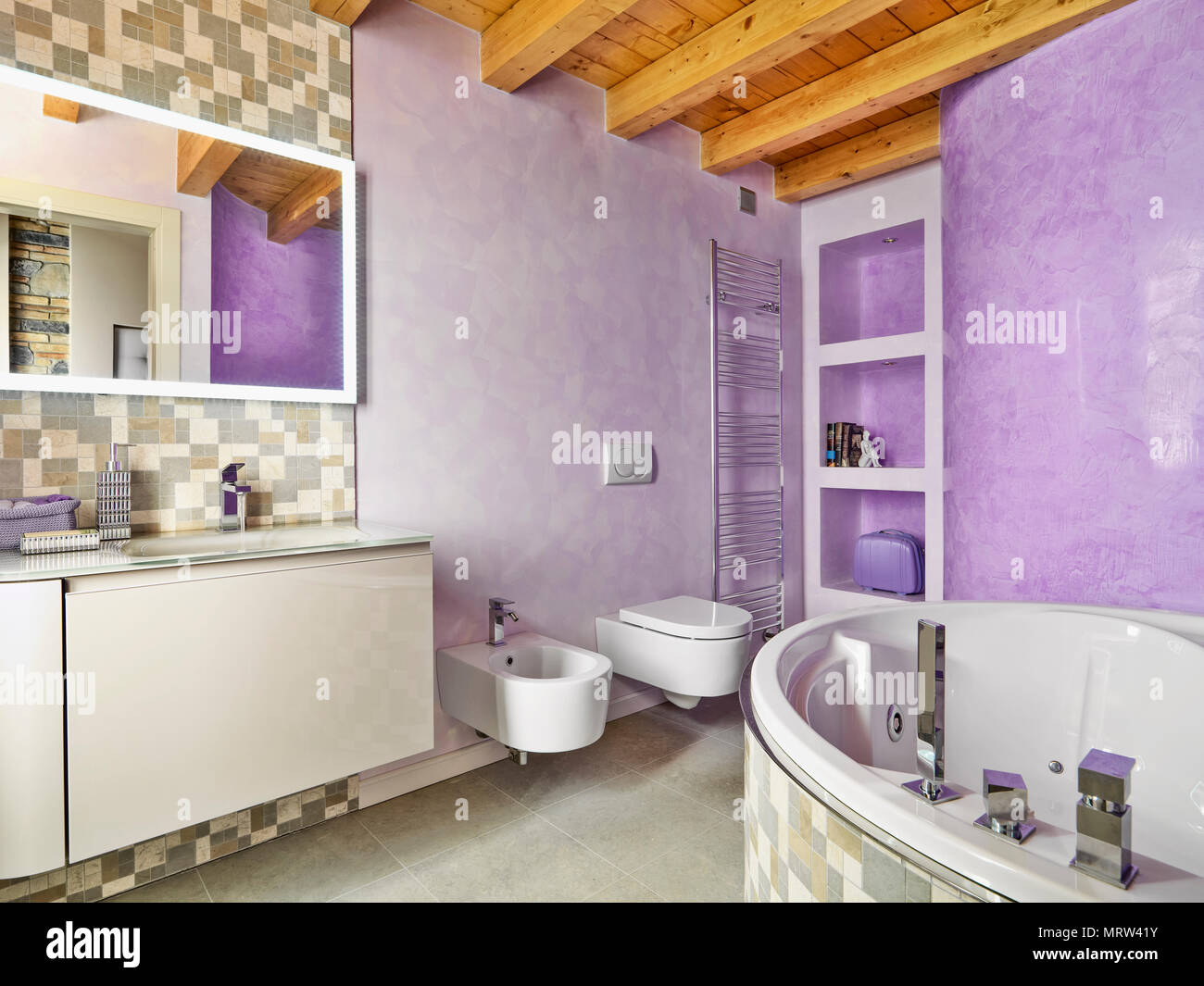 modern bathroom interior in the foreground the angular bathtub and to left a wooden furniture with a built-in washbasin on the background the niches,  Stock Photo