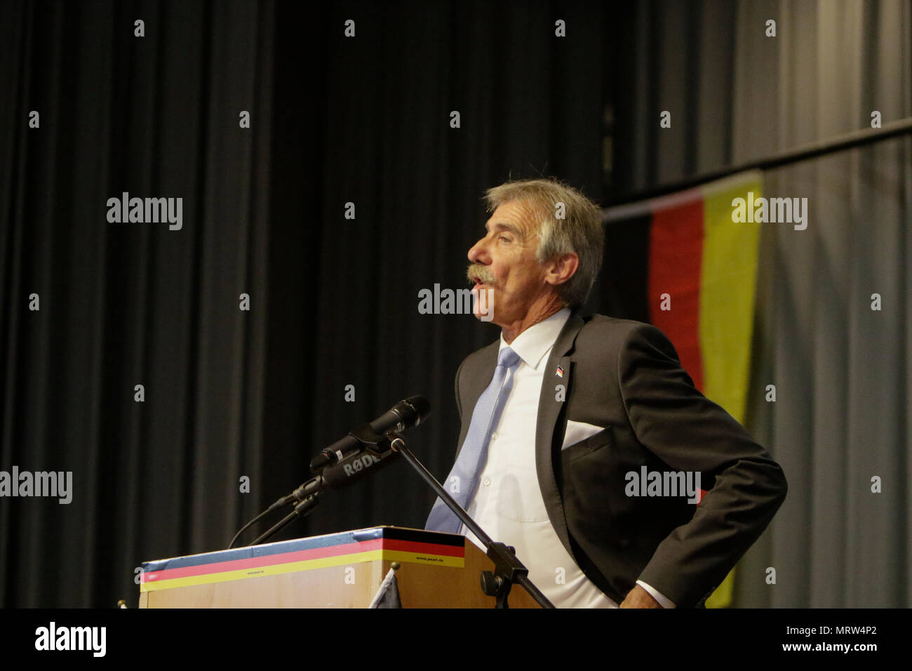 Jockgrim, Germany. 26th May, 2018. The parliamentary leader of the AfD party in the Landtag (parliament) of Rhineland-Palatinate Uwe Junge speaks on the podium. The parliamentary group of the right-wing populist AfD (Alternative for Germany) party of Rhineland-Palatinate celebrated the 2nd anniversary of their entry into the Rhineland-Palatinate state parliament in the 2016 state election in the South Palatinate city of Jockgrim. A counter-protest was organised by several groups outside the venue. Credit: Michael Debets/Pacific Pres/Alamy Live News Stock Photo