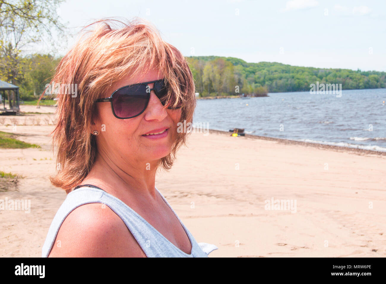 portrait retired woman on vacation at the beach Maskinonge Lake St-Gabriel-de-Brandon Quebec Canada Stock Photo
