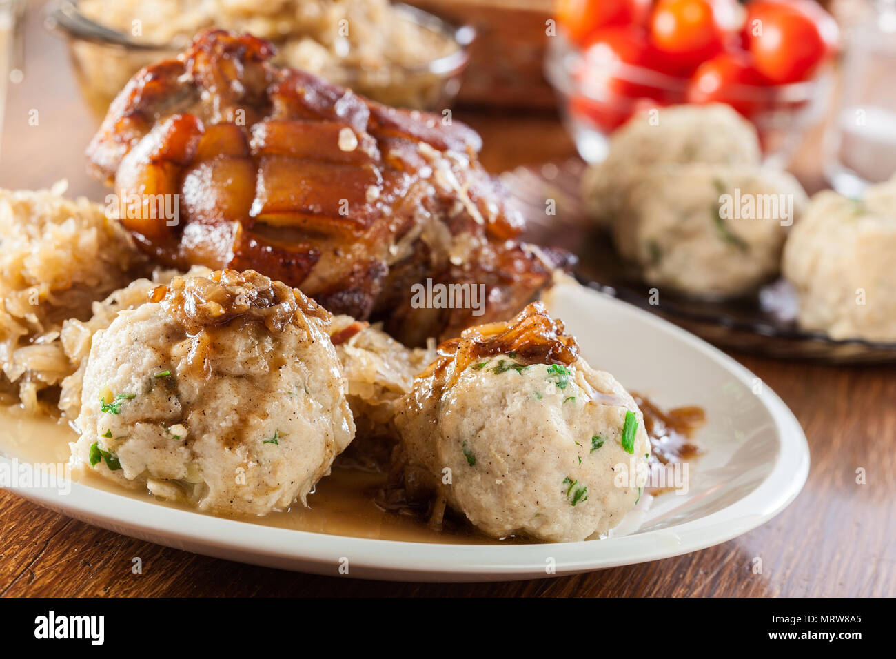 Pork knuckle with fried sauerkraut and bread dumplings Stock Photo Alamy
