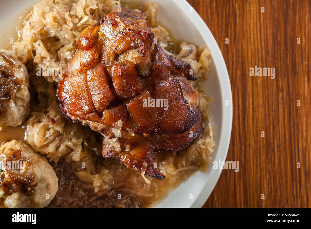 Pork knuckle with fried sauerkraut and bread dumplings. Top view Stock