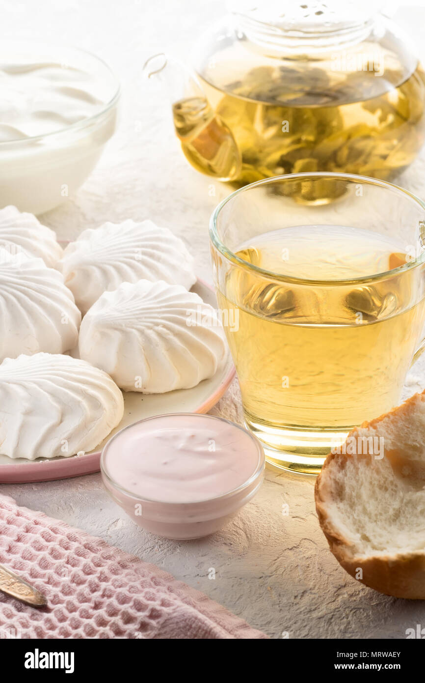 Protein products ingredients for breakfast marshmallows sour cream yogurt milk piece of bread green tea Stock Photo