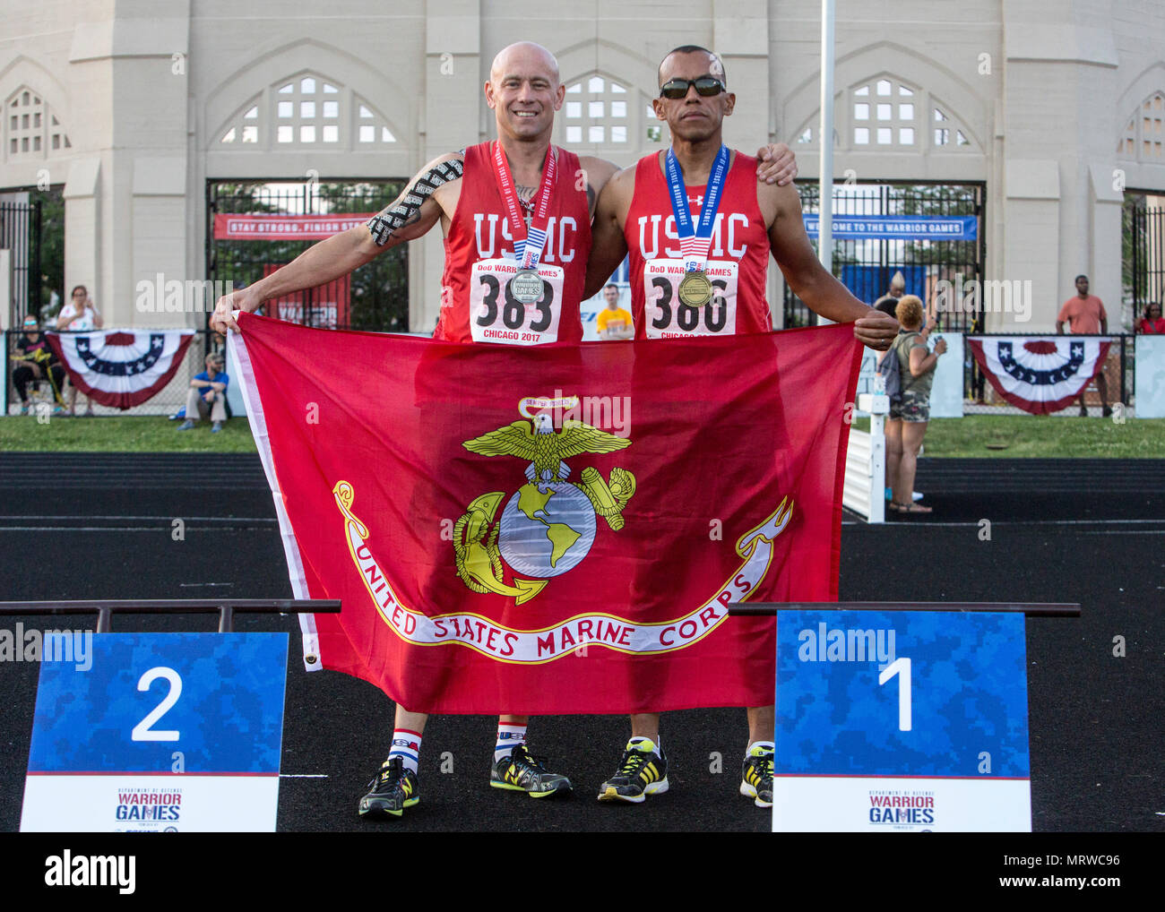 U.S. Marine Corps Sgt. Maj. Brian Fogarty, left, and Master Sgt. Hugo Gonzalez Orozco, right, pose for a photo after taking silver and gold medals, respectively, in a men’s 1,500-meter race during a 2017 DoD Warrior Games Track Competition at Lane Technical College Preparatory High School in Chicago July 2, 2017. The DoD Warrior Games is an adaptive sports competition for wounded, ill and injured service members and veterans. (U.S. Marine Corps photo by Lance Cpl. Nadia J. Stark) Stock Photo