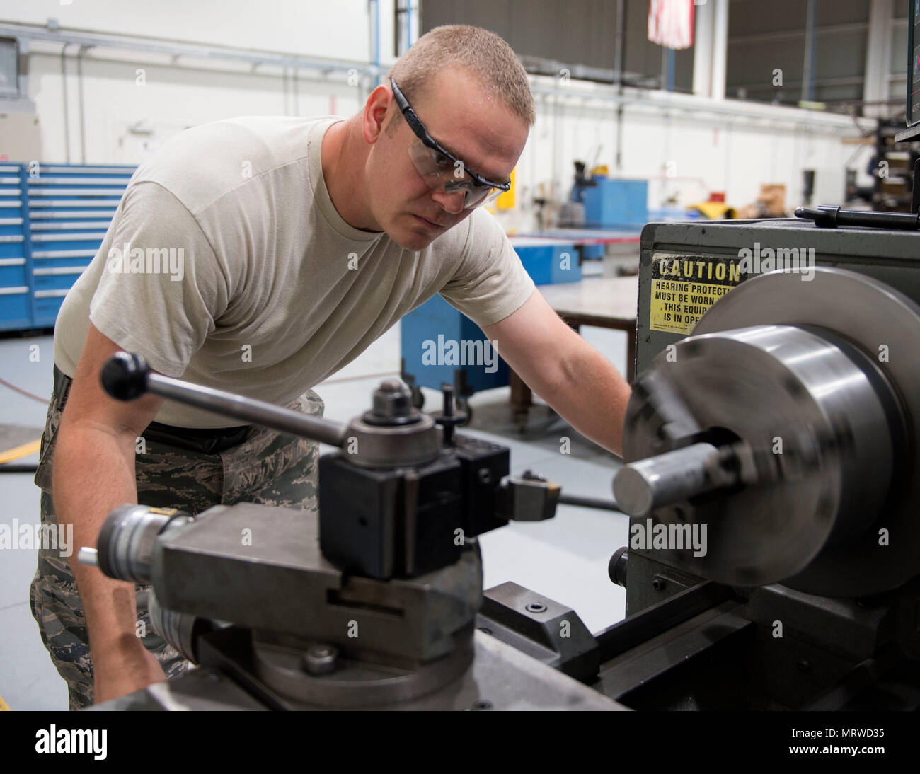 U.S. Air Force Staff Andrew Walker, a fabrication specialist with the 379th Expeditionary Maintenance Squadron uses a manual lathe to create a cylindrical part at Al Udeid Air Base, Qatar, June 5, 2017. Walker is part of a team of machinists and welders which are trained on a wide range of manual and computer numerical controlled machines to manufacture and repair aircraft components and support equipment. (U.S. Air Force photo by Tech. Sgt. Amy M. Lovgren) Stock Photo