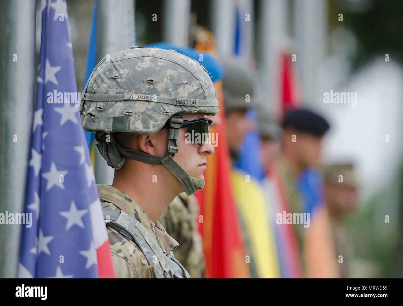 Soldiers from Armenia, Croatia, Montenegro, Romania, Ukraine and the United States wait to raise their nation’s flag during the official opening ceremony of multinational training exercise Getica Saber 17 at Joint National Training Center in Cincu, Romania, July 7, 2017. Getica Saber 17 is a U.S-led fire support coordination exercise and combined arms live-fire exercise that incorporates six Allied and partner nations with more than 4,000 Soldiers. Getica Saber runs concurrent with Saber Guardian, a U.S. Army Europe-led, multinational exercise that spans across Bulgaria, Hungary and Romania wi Stock Photo