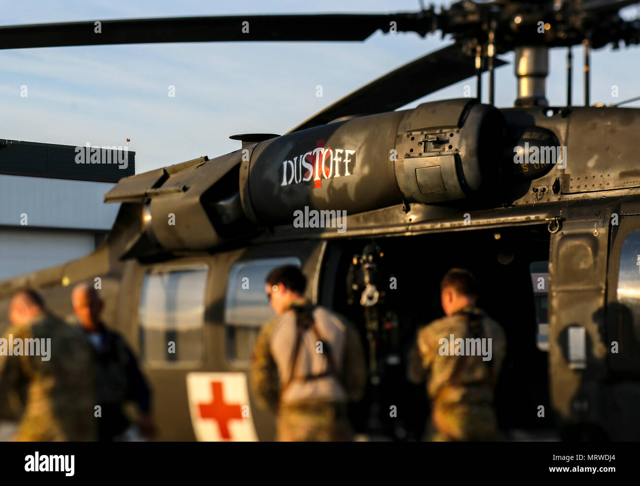 Members of New Jersey Task Force One are briefed on the hoist system on a UH-60 Black Hawk helicopter during joint training at Joint Base McGuire-Dix-Lakehurst, N.J., June 28, 2017. The primary mission of New Jersey Task Force One is to provide advanced technical search and rescue capabilities to victims trapped or entombed in structurally collapsed buildings. (U.S. Air National Guard photo by Master Sgt. Matt Hecht/Released) Stock Photo
