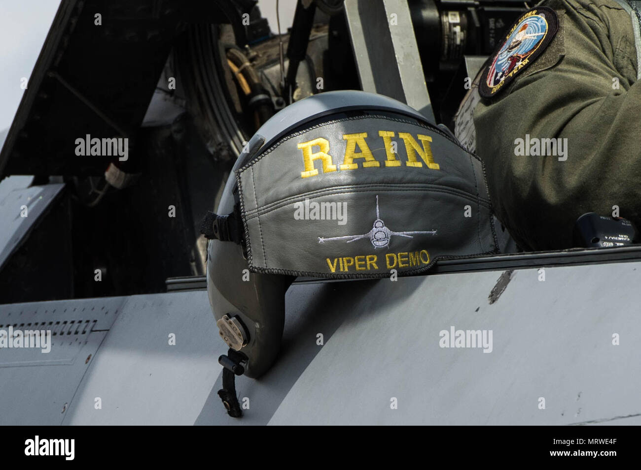 A helmet rests next to U.S. Air Force Maj. John Waters, F16 Viper Demonstration Team pilot, at