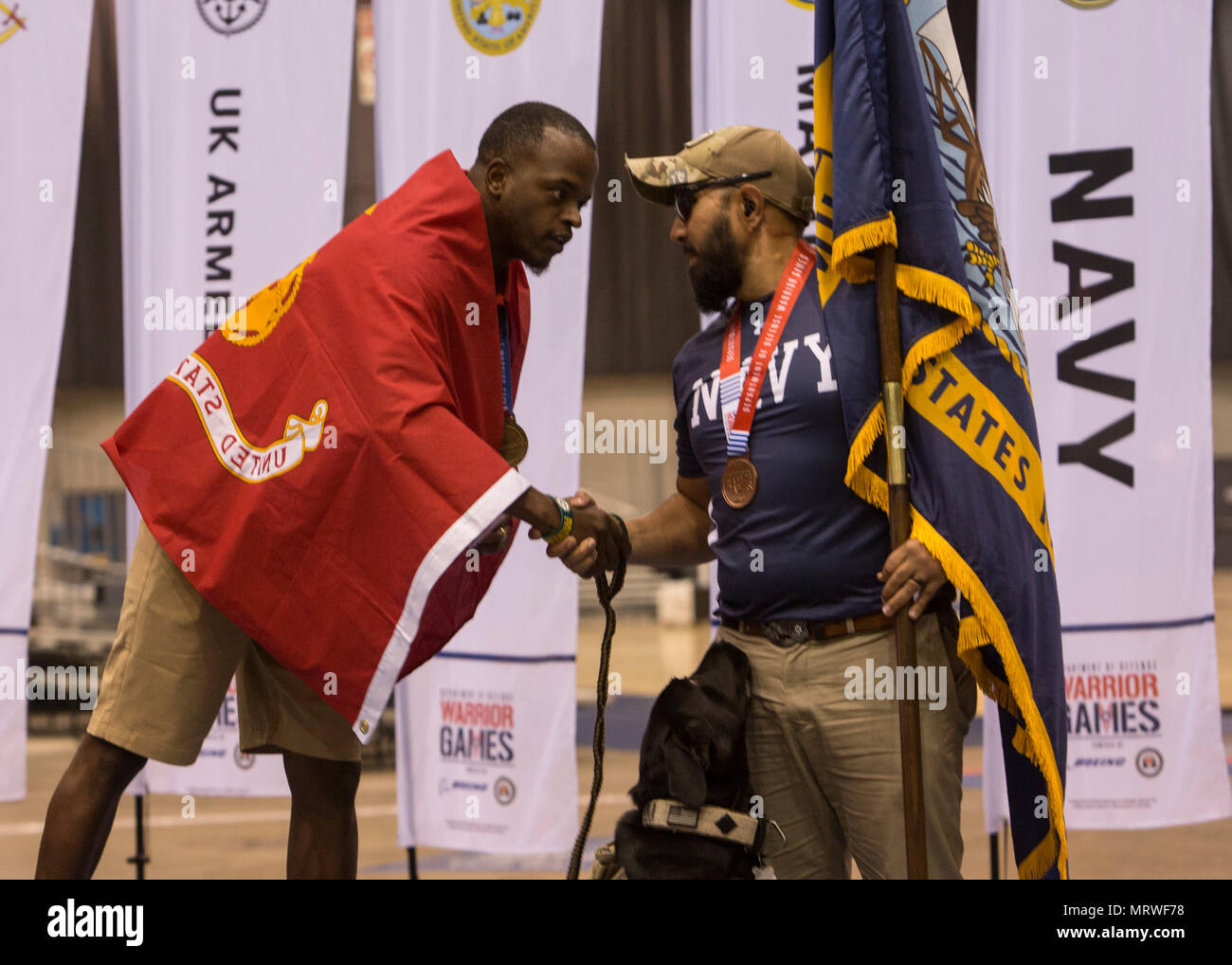 U.S. Marine Corps veteran Leon Pierce congratulates an athlete from Team Navy after the 2017 DoD Warrior Games Archery Competition at McCormick Place in Chicago July 3, 2017. Pierce, a native of Northridge, Calif., is a member of Team Marine Corps. The DoD Warrior Games is an adaptive sports competition for wounded, ill and injured service members and veterans. (U.S. Marine Corps photo by Lance Cpl. Nadia J. Stark) Stock Photo