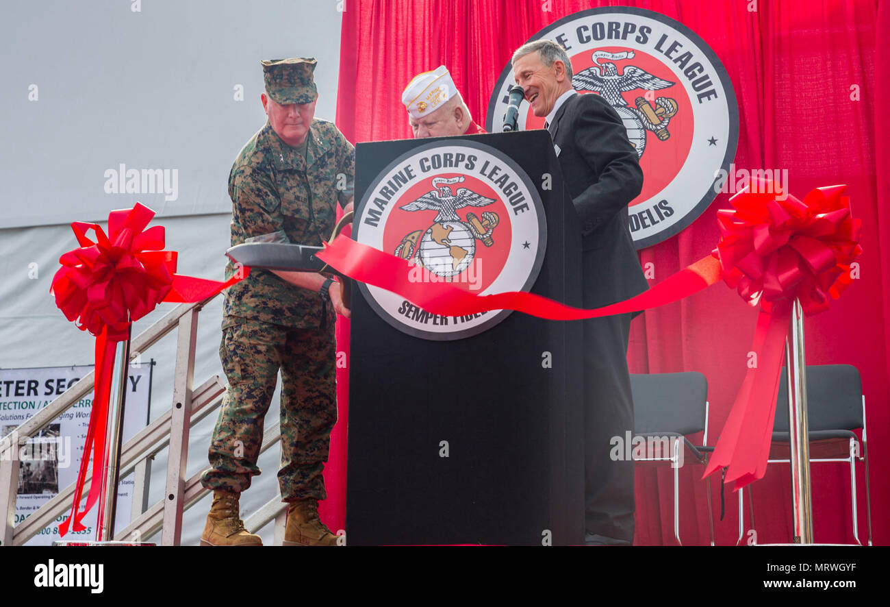 U.S. Marine Corps Maj. Gen. Walter L. Miller Jr., left, commanding general, II Marine Expeditionary Force, Richard D. Gore Sr., center, commandant, Marine Corps League, and retired Maj. Gen. Michael Regner, staff director, Headquarters Marine Corps, cut the ribbon at the opening ceremony for the Marine South Military Exposition, Goettege Field House, Camp Lejeune N.C., April 13, 2017. The Marine South Exposition is sponsored by the Marine Corps League and is a forum for defense contractors to display, inform, and promote the latest in defense equipment and technology. Stock Photo
