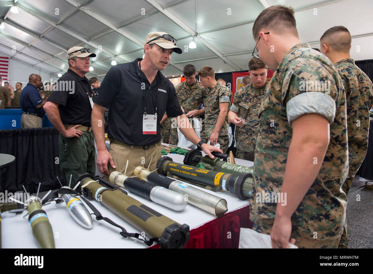 Dave Rolen, director of field marketing, Nordic Ammunition, explains different weapon systems to Marines and Sailors during the Marine South Military Exposition, Goettege Field House, Camp Lejeune N.C., April 13, 2017. The Marine South Exposition is sponsored by the Marine Corps League and is a forum for defense contractors to display, inform, and promote the latest in defense equipment and technology. Stock Photo