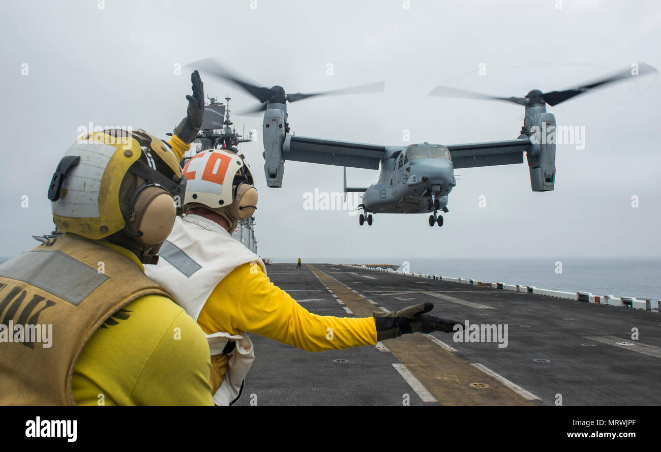 170709-N-LI768-1271  PACIFIC OCEAN (July 9, 2017) USS Makin Island (LHD 8) Commanding Officer Capt. Mark A. Melson signals for an MV-22B Osprey, assigned to the “Red Lions” of Marine Medium Tiltrotor Squadron (VMM) 363, to take off from the flight deck of the amphibious assault ship. Makin Island is conducting operations off the coast of Southern California. (U.S. Navy photo by Mass Communication Specialist 2nd Class Devin M. Langer) Stock Photo
