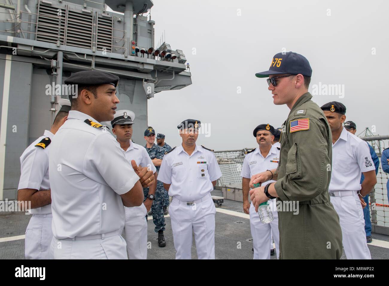 170711-N-VR594-0673  CHENNAI, India (July 11, 2017) Lt. Joseph Cusick, from Yorba Linda, Calif., gives a tour of the Ticonderoga-class guided-missile cruiser USS Princeton (CG 59) to members of the Indian Navy during Malabar 2017. Malabar 2017 is the latest in a continuing series of exercises between the Indian Navy, Japan Maritime Self Defense Force and U.S. Navy that has grown in scope and complexity over the years to address the variety of shared threats to maritime security in the Indo-Asia-Pacific region. (U.S. Navy photo by Mass Communication Specialist 3rd Class Kelsey J. Hockenberger/R Stock Photo