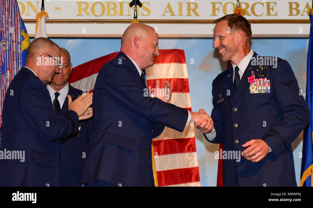 U.S. Air Force Col. Mark Weber, outgoing commander of the 116th Air Control Wing (ACW), Georgia Air National Guard, congratulates Col. Thomas Grabowski, incoming commander of the 116th ACW, during a change of command ceremony at the Museum of Aviation, Robins Air Force Base, Ga., July 10, 2017. Grabowski takes command of the 116th ACW after serving approximately two years as vice commander under Col. Mark Weber. (U.S. Air National Guard photo by Master Sgt. Regina Young) Stock Photo