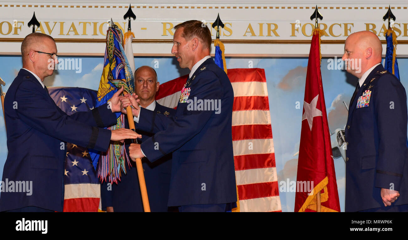 U.S. Air Force Col. Mark Weber, commander of the 116th Air Control Wing (ACW), Georgia Air National Guard, relinquishes the 116th ACW guidon to Maj. Gen. Jesse Simmons, assistant adjutant general – Air, Georgia National Guard and commander of the Georgia Air National Guard, during a change of command ceremony at the Museum of Aviation, Robins Air Force Base, Ga., July 10, 2017. Col. Thomas Grabowski takes command of the 116th ACW after serving approximately two years as vice commander under Weber. (U.S. Air National Guard photo by Master Sgt. Regina Young) Stock Photo